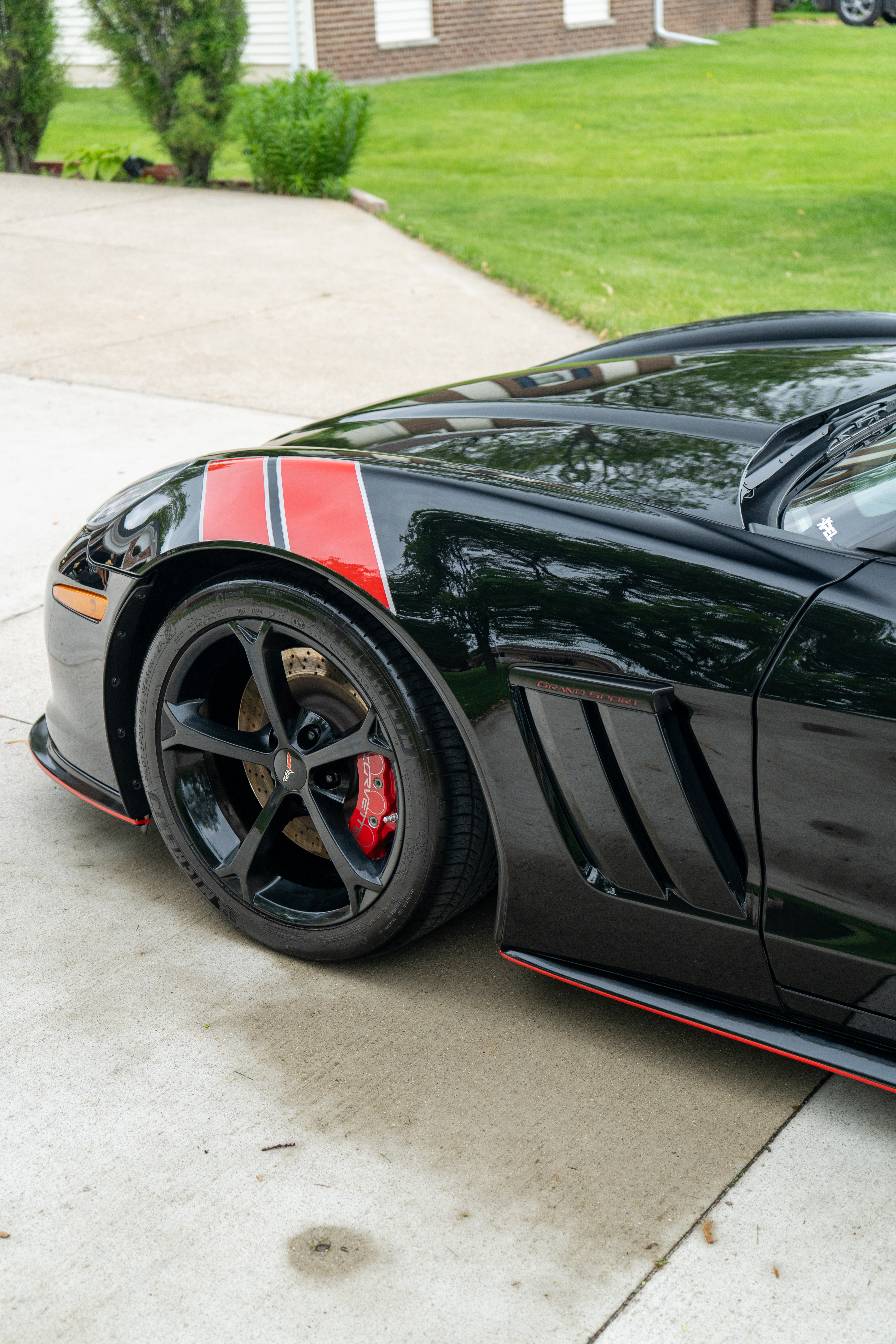 Black Chevrolet Corvette with System X ceramic coating, front quarter showing reflective gloss