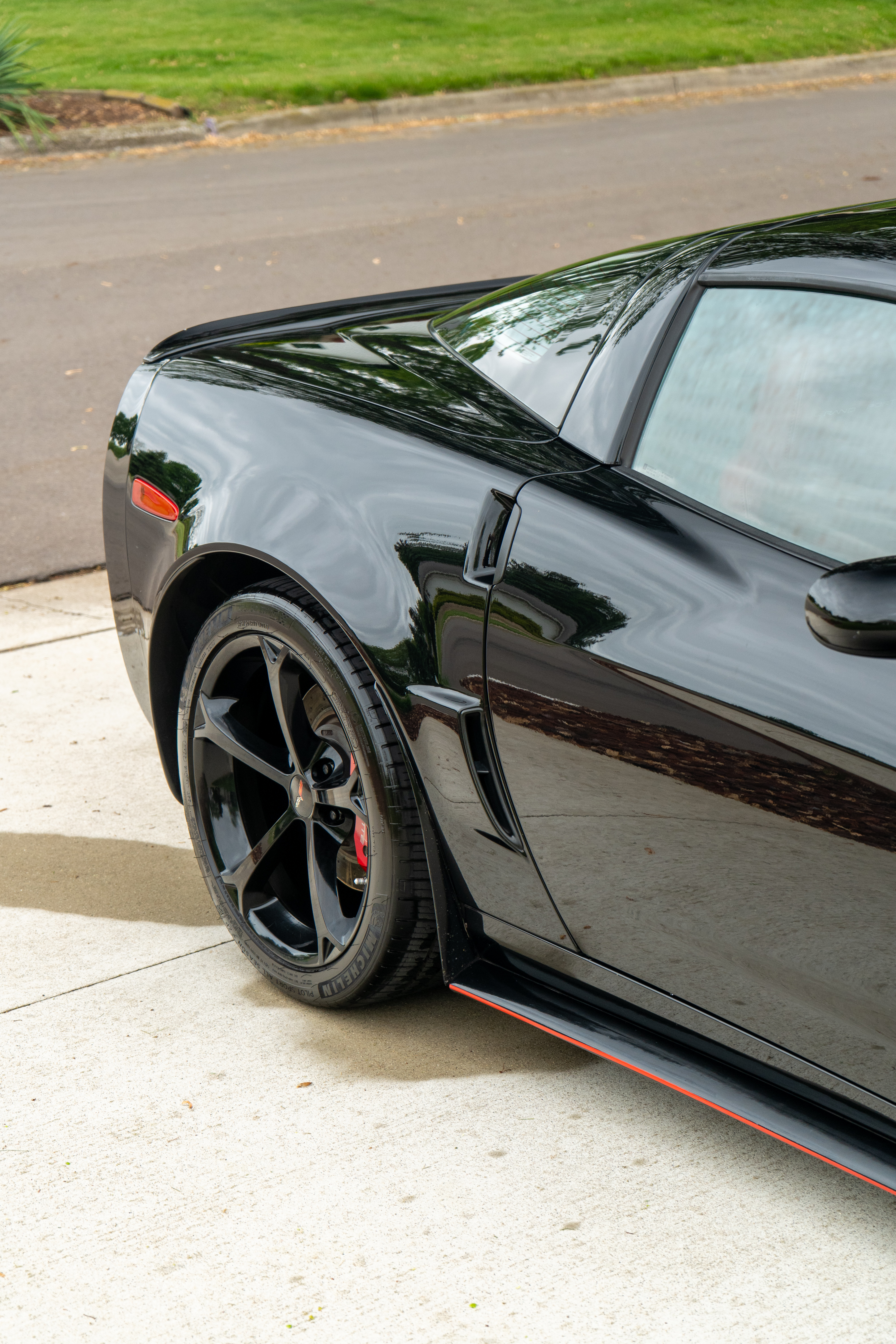 Black Chevrolet Corvette with System X ceramic coating, rear wheel detail