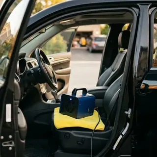 Ozone generator running inside a vehicle cabin during an odor elimination treatment by After Hours Car Detailing
