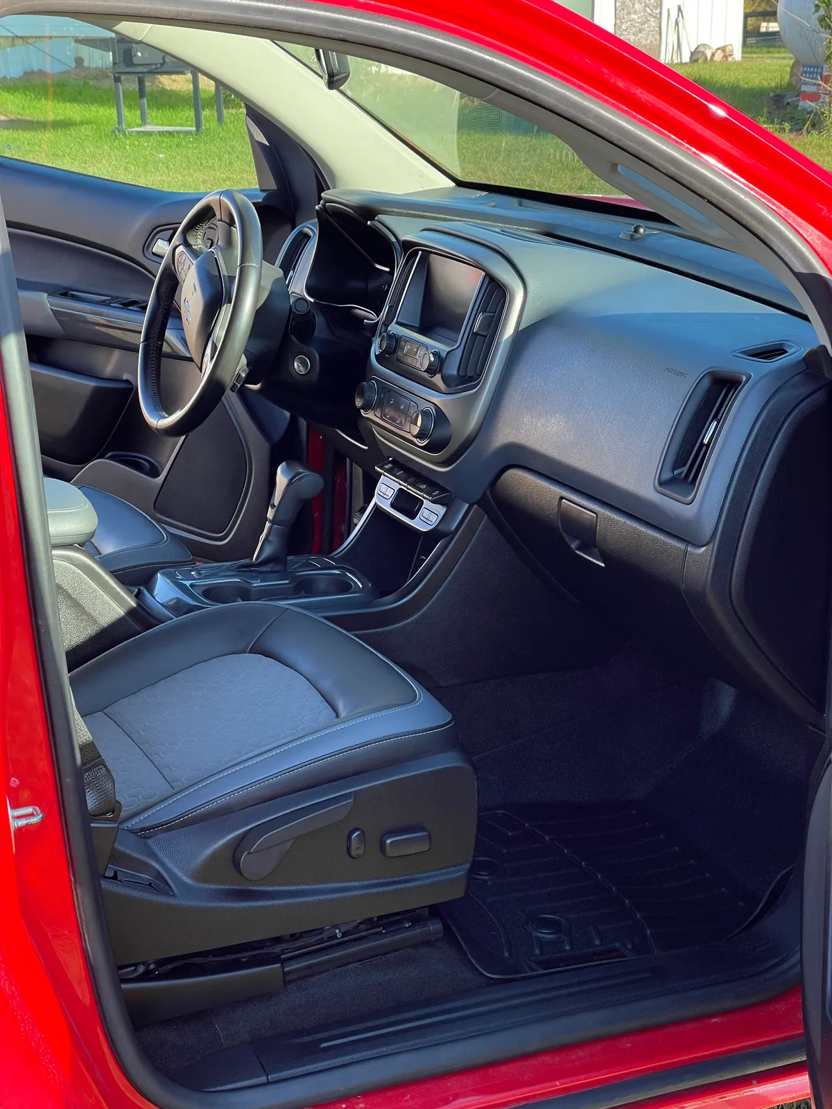 Spotless interior of a red vehicle after a full interior detail and steam clean by After Hours Car Detailing