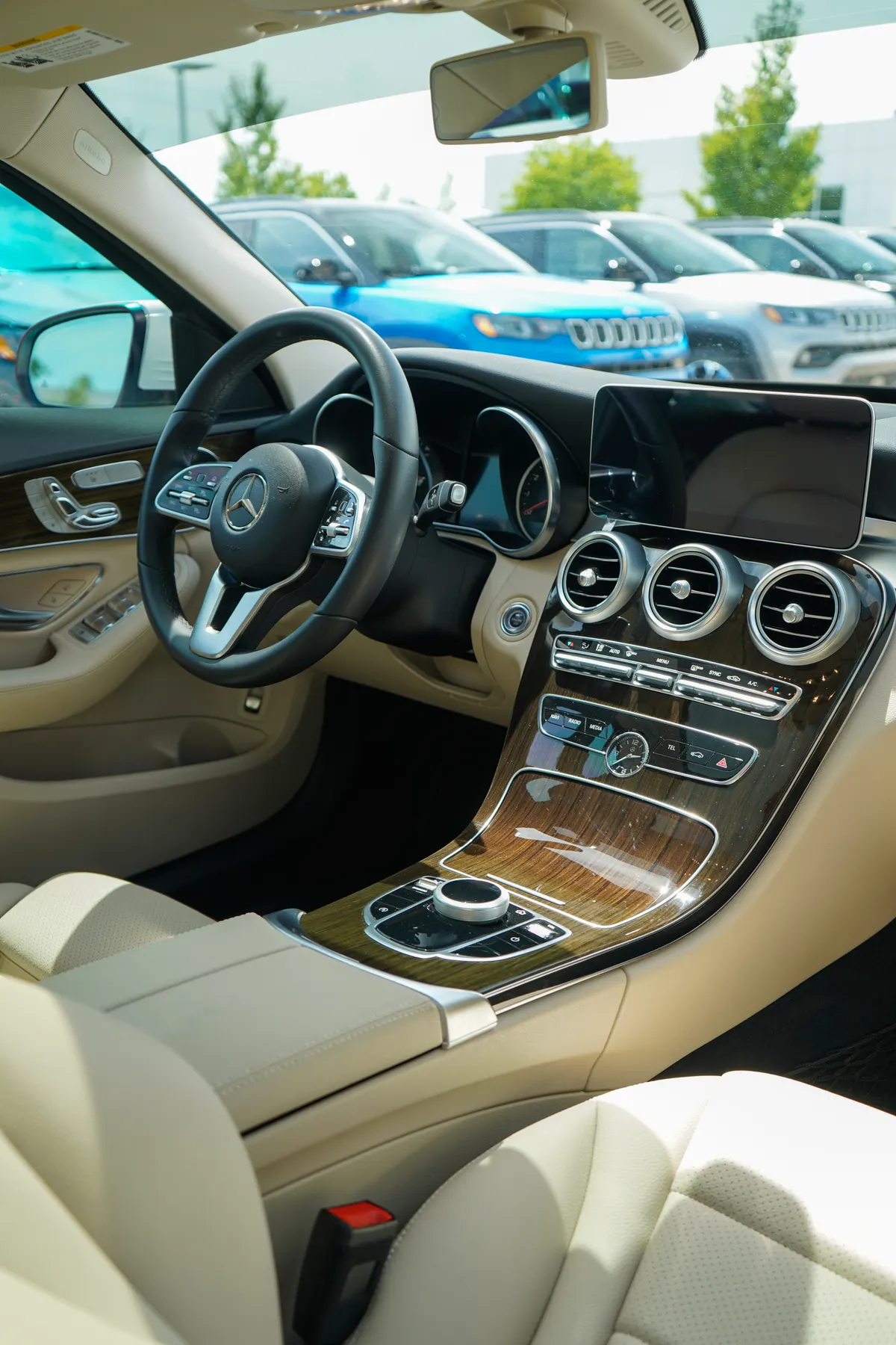 Mercedes-Benz C-Class interior after a full detail — cream leather seats, wood trim, and dash cleaned and conditioned by After Hours Car Detailing