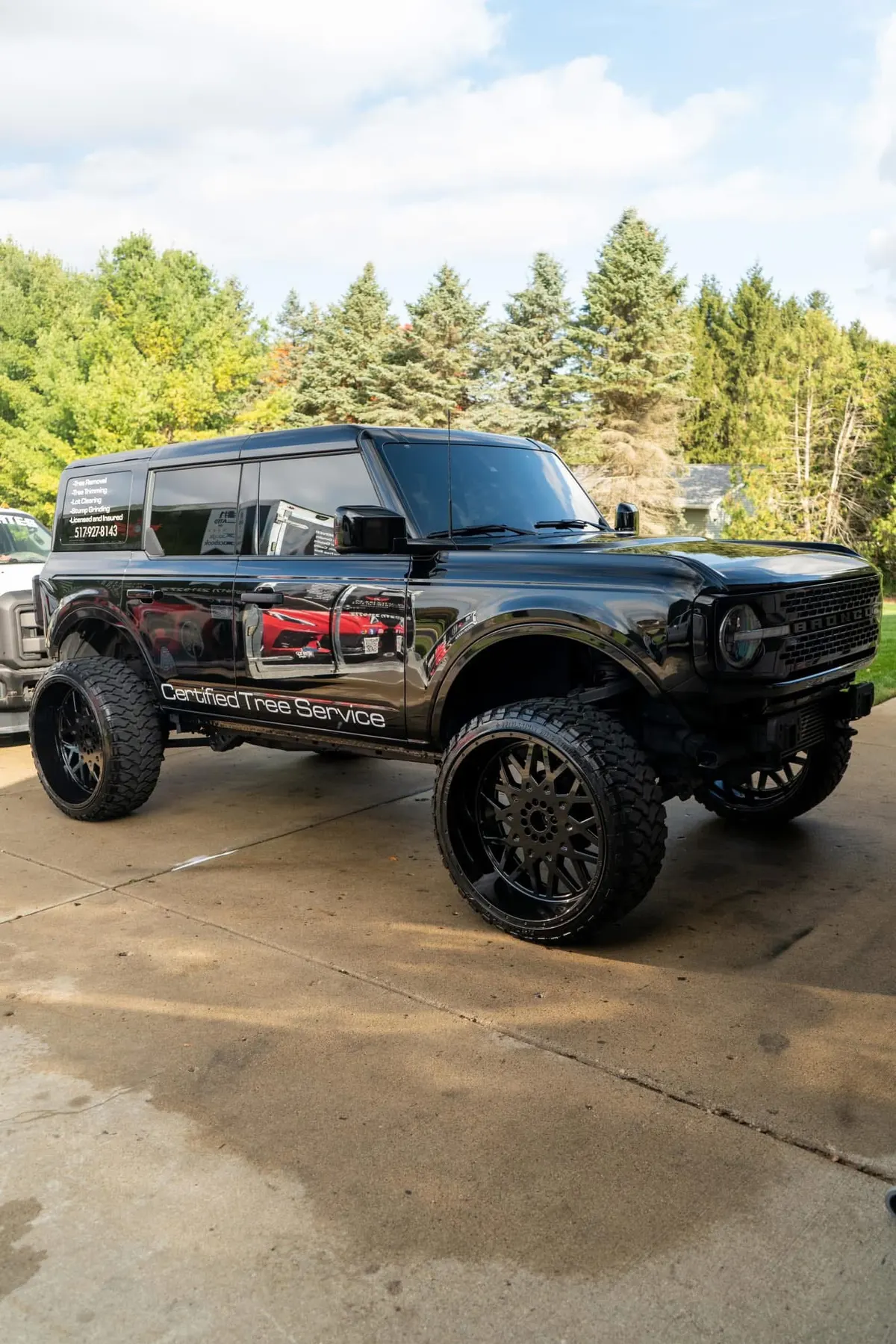 Lifted black Ford Bronco wrapped for Certified Tree Service, detailed by After Hours Car Detailing