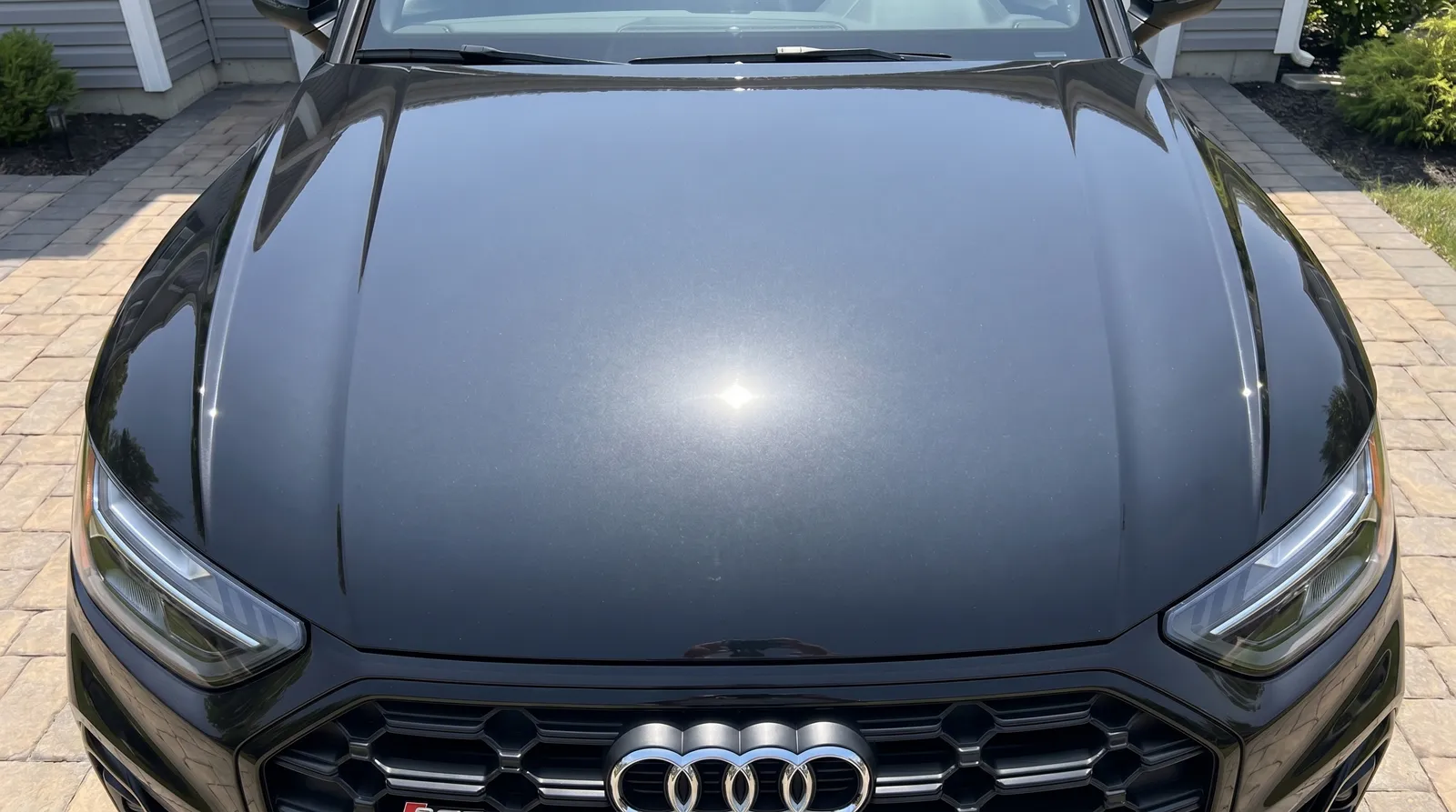 Black Audi S4 hood 1-step paint correction before and after — light to moderate swirls removed — after