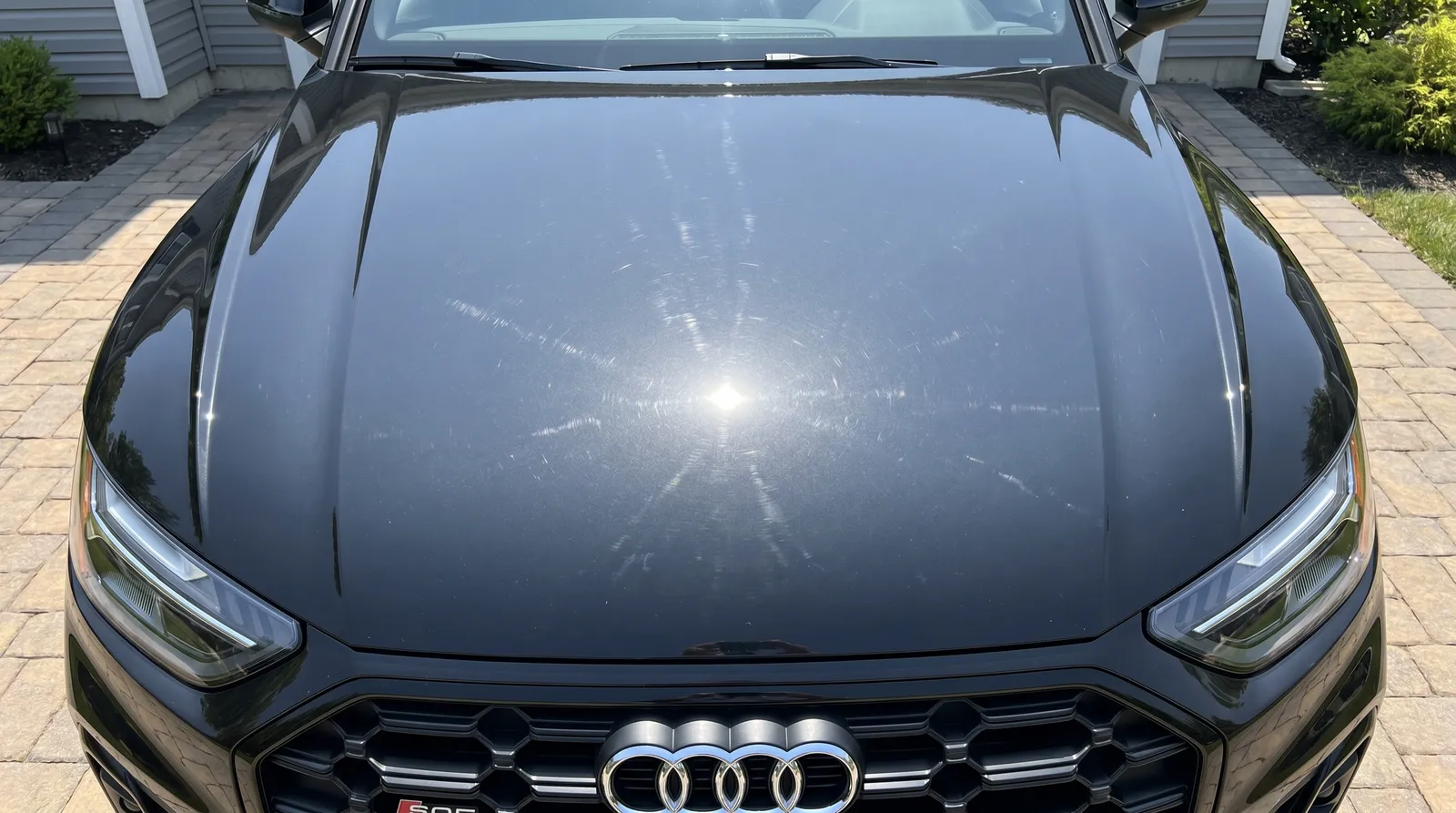 Black Audi S4 hood 1-step paint correction before and after — light to moderate swirls removed — before